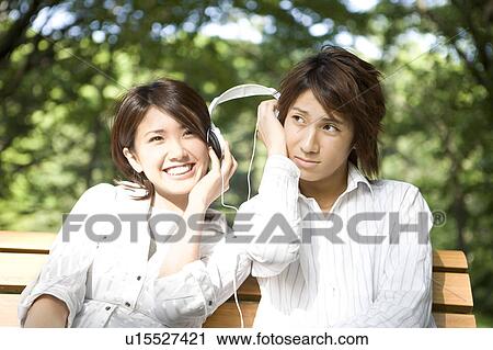 Stock Image - Couple who sits on the bench. Fotosearch
