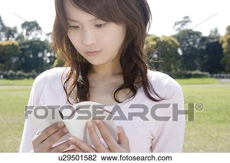 Stock Image - Woman reading book. Fotosearch