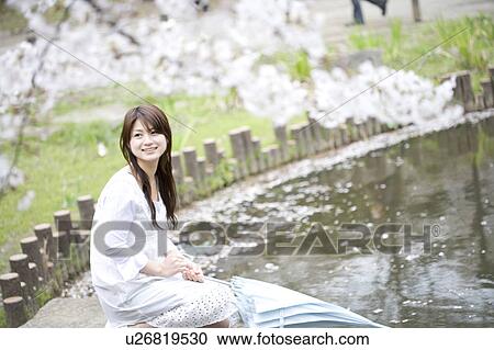 Woman under the cherry tree View Large Photo Image Stock Image - Woman under the cherry tree. Fotosearch