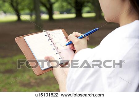 Woman who attends a notebook View Large Photo Image Stock Image - Woman who attends a notebook. Fotosearch