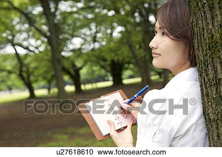 Stock Image - Woman who attends a notebook. Fotosearch