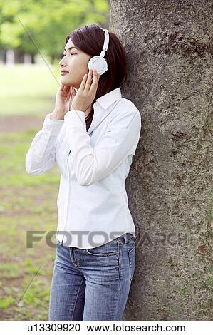 Stock Image - Woman who hangs upon the music. Fotosearch