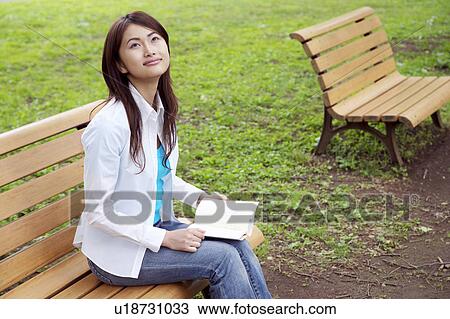 Woman who reads with the bench View Large Photo Image Stock Image - Woman who reads with the bench. Fotosearch