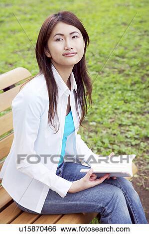 Stock Photograph - Woman who reads with the bench. Fotosearch