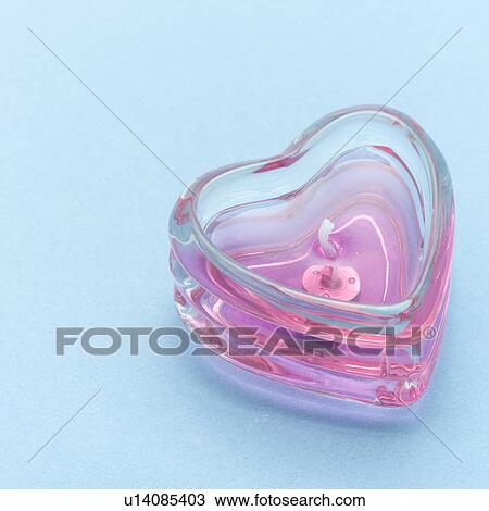Stock Image - Heart-shaped candle. Fotosearch