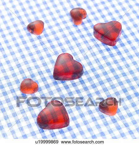 Stock Photo - Heart-shaped objects on check cloth. Fotosearch