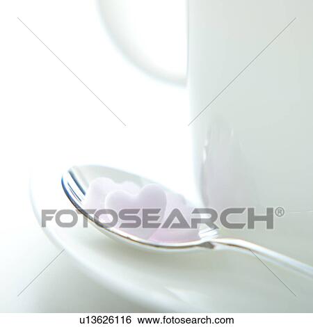 Stock Photograph - Heart-shaped sugar on spoon. Fotosearch