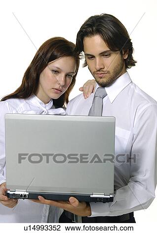 Close-up of a businessman and a businesswoman using a laptop View Large Photo Image Stock Image - Close-up of a businessman and a businesswoman using a laptop. Fotosearch