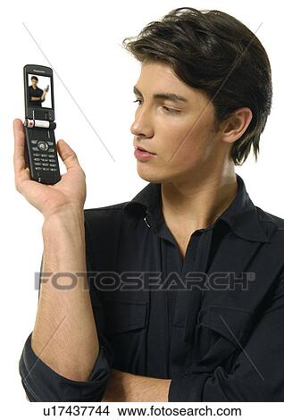 Picture - Close-up of a young man holding a mobile phone. Fotosearch