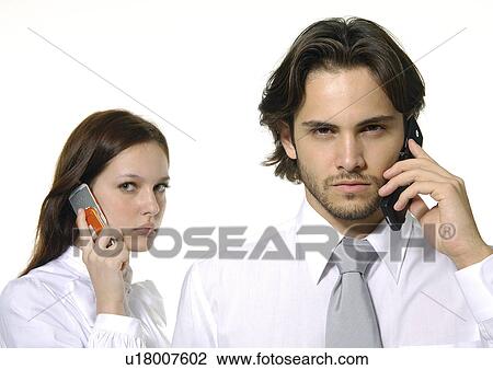 Portrait of a businessman and a businesswoman using mobile phones View Large Photo Image Stock Image - Portrait of a businessman and a businesswoman using mobile phones. Fotosearch