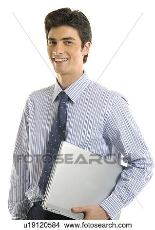 Picture - Portrait of a businessman holding a laptop and smiling. Fotosearch