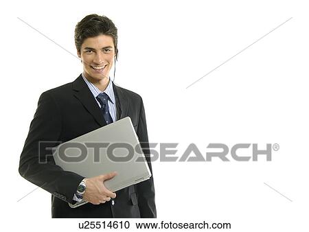 Portrait of a businessman holding a laptop and smiling View Large Photo Image Stock Image - Portrait of a businessman holding a laptop and smiling. Fotosearch