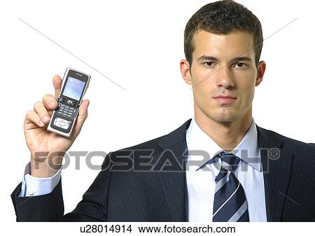 Picture - Portrait of a businessman showing a mobile phone. Fotosearch