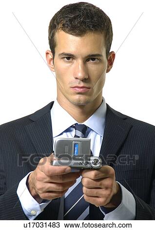Stock Image - Portrait of a businessman showing a mobile phone. Fotosearch