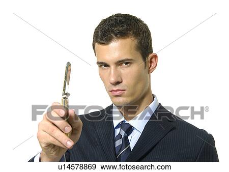 Stock Photo - Portrait of a businessman showing a mobile phone. Fotosearch
