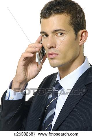 Stock Photo - Portrait of a businessman using a mobile phone. Fotosearch