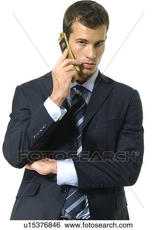 Stock Photograph - Portrait of a businessman using a mobile phone. Fotosearch