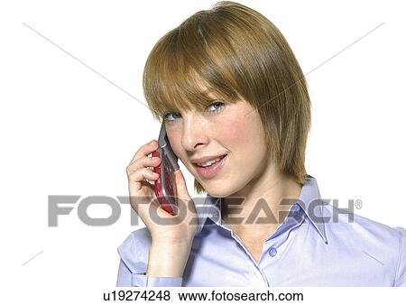 Portrait of a young woman talking on a mobile phone View Large Photo Image Stock Photo - Portrait of a young woman talking on a mobile phone. Fotosearch
