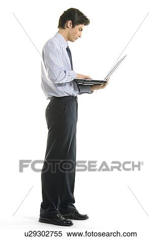 Stock Photography - Side profile of a businessman using a laptop. Fotosearch