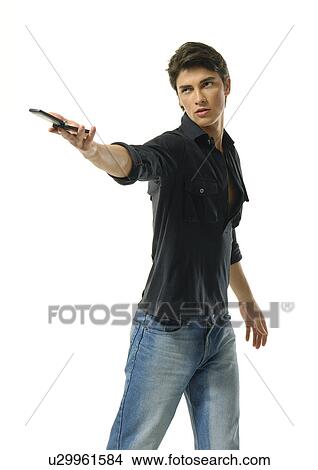 Picture - Young man offering a mobile phone. Fotosearch