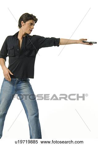 Stock Photography - Young man offering a mobile phone. Fotosearch