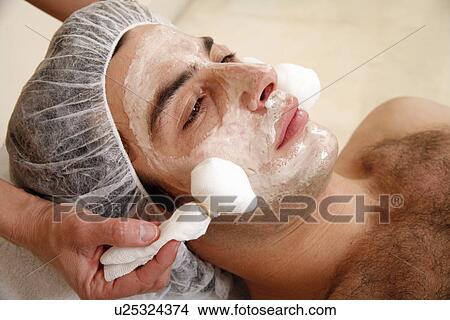 Picture - Man having a facial treatment in a spa. Fotosearch