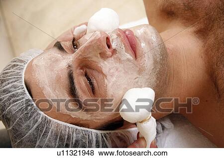 Stock Photo - Man having a facial treatment in a spa. Fotosearch