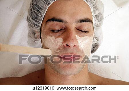 Stock Photograph - Man having a facial treatment in a spa. Fotosearch