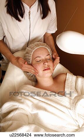 Woman having a facial treatment at a spa View Large Photo Image Picture - Woman having a facial treatment at a spa. Fotosearch