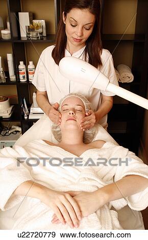 Woman having a facial treatment at a spa View Large Photo Image Stock Photo - Woman having a facial treatment at a spa. Fotosearch