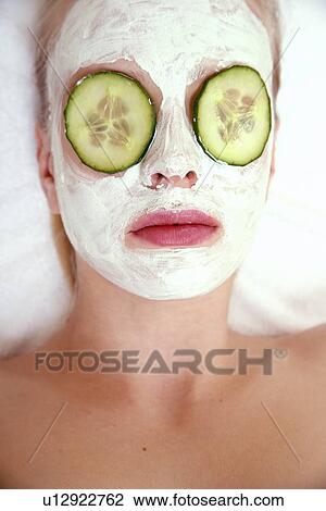 Stock Image - Woman having a facial treatment in a spa. Fotosearch