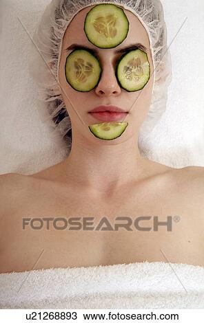 Stock Image - Woman having a facial treatment in a spa. Fotosearch