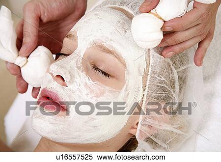 Stock Photography - Woman having a facial treatment in a spa. Fotosearch