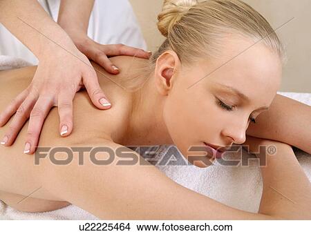 Picture - Young woman enjoying a massage . Fotosearch