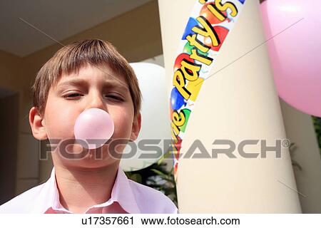 Stock Image - Boy doing bubble with gum. Fotosearch
