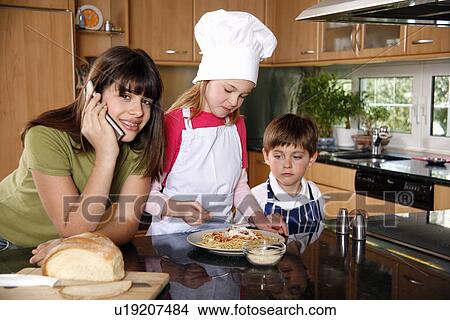 Picture - Children cooking spaghetti. Fotosearch