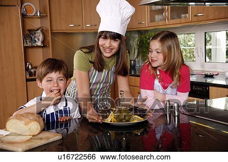 Stock Photograph - Children cooking spaghetti. Fotosearch
