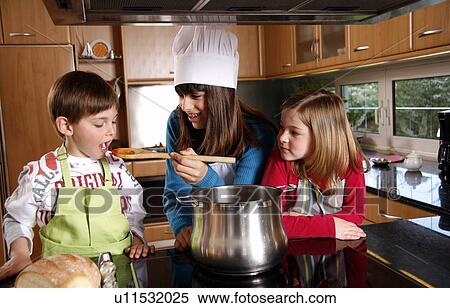 Stock Photography - Children cooking spaghetti. Fotosearch