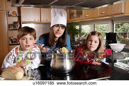 Stock Photography - Children cooking spaghetti. Fotosearch