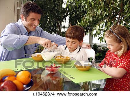 Father and children eating breakfast View Large Photo Image Picture - Father and children eating breakfast. Fotosearch