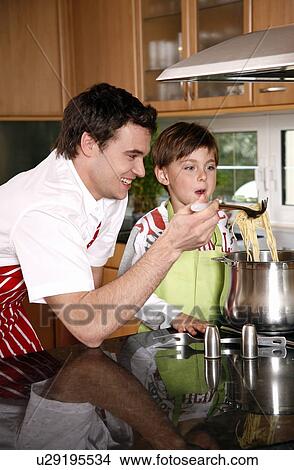 Father and son cooking spaghetti View Large Photo Image Picture - Father and son cooking spaghetti. Fotosearch