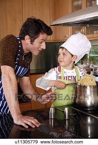 Father and son cooking spaghetti View Large Photo Image Stock Photo - Father and son cooking spaghetti. Fotosearch
