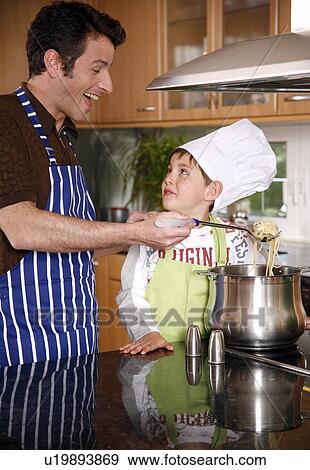 Father and son cooking spaghetti View Large Photo Image Stock Photo - Father and son cooking spaghetti. Fotosearch