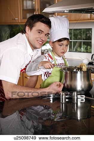 Stock Photo - Father and son cooking spaghetti. Fotosearch