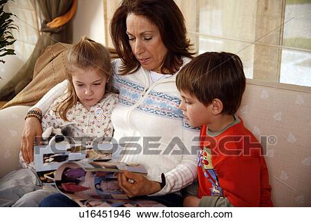 Grandmother relaxing with grandchildren View Large Photo Image Stock Photograph - Grandmother relaxing with grandchildren. Fotosearch