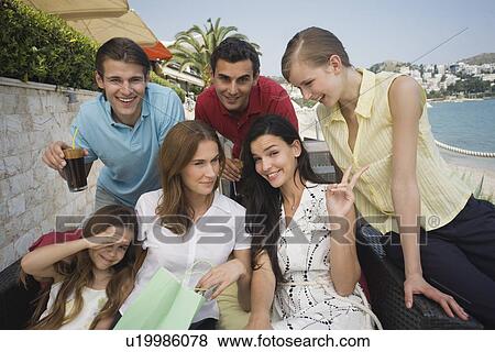 Group of friends with shopping bags posing View Large Photo Image Stock Photo - Group of friends with shopping bags posing. Fotosearch