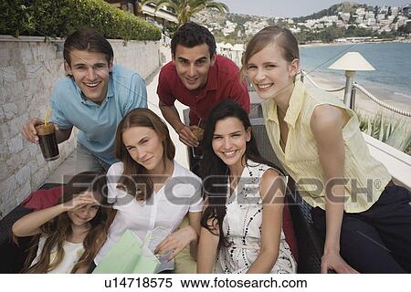 Group of friends with shopping bags posing View Large Photo Image Stock Photography - Group of friends with shopping bags posing. Fotosearch