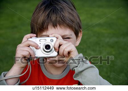Stock Photo - Little boy holding a camera. Fotosearch