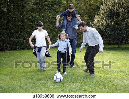 Man and children playing soccer View Large Photo Image Stock Photo - Man and children playing soccer. Fotosearch