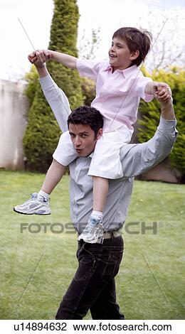Man carrying a little boy on his shoulders View Large Photo Image Stock Image - Man carrying a little boy on his shoulders. Fotosearch